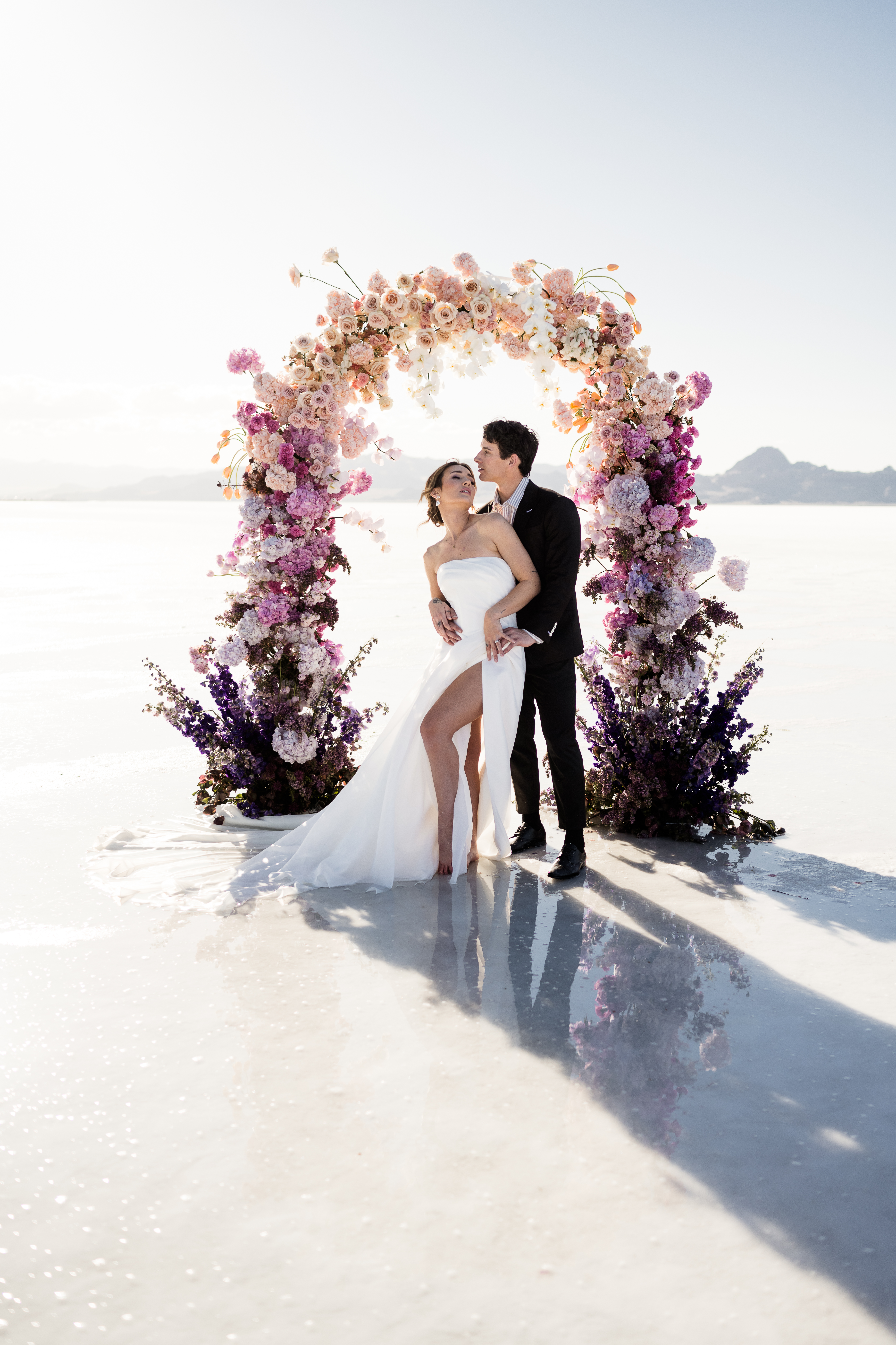 Dreamy Salt Flats elopement with a couple and a stunning flower arch backdrop.
