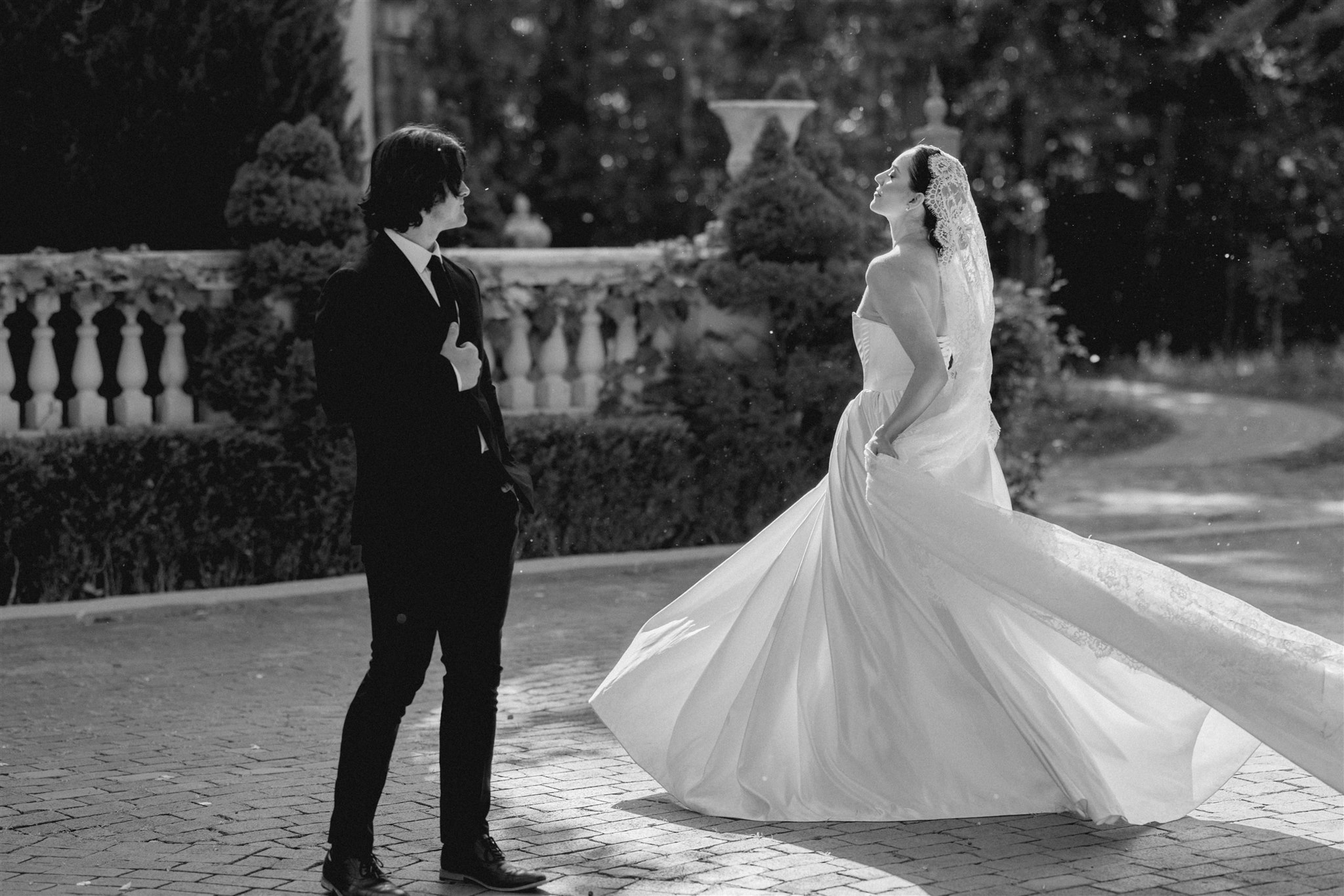 Bride and groom in the gardens at La Caille, a romantic wedding venue in Utah with mountain views and European-style architecture.