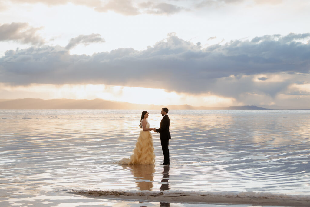 Golden hour wedding photography at Pink Lake Utah showing vibrant blue water.