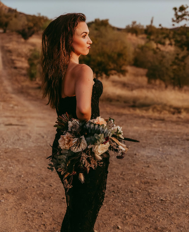 Ryann Kristena, one of the wedding planners Salt Lake City has to offer, poses with a bouquet.