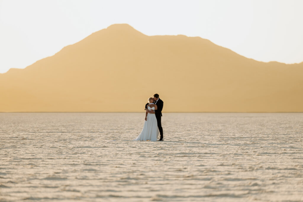 Couple eloping at the Bonneville Salt Flats at sunset.