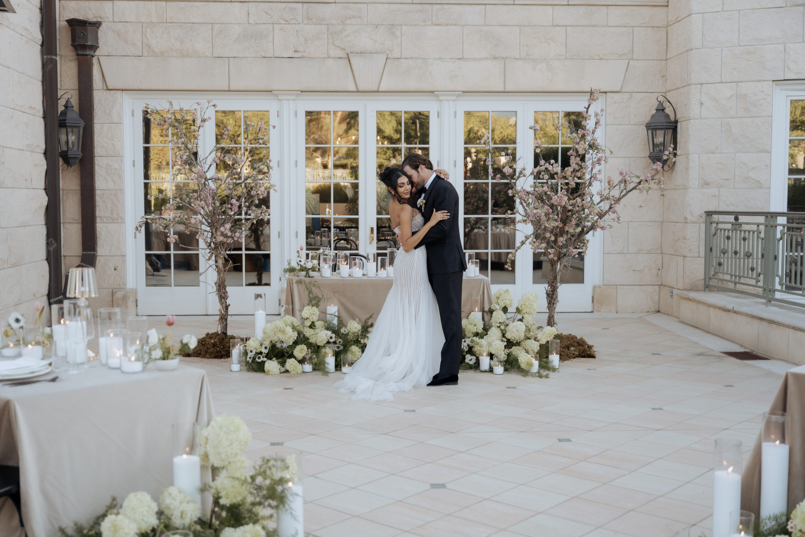 Wedding portrait in front of UVU library with brick architecture and large windows.