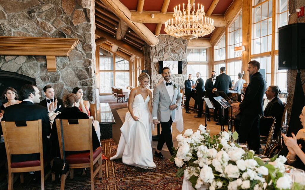 Bride and groom at Snowbasin Resort Utah with panoramic mountain views and indoor lodge.