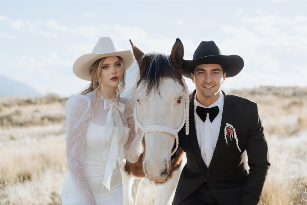 Bride and groom walking with horse during western elopement in Utah
